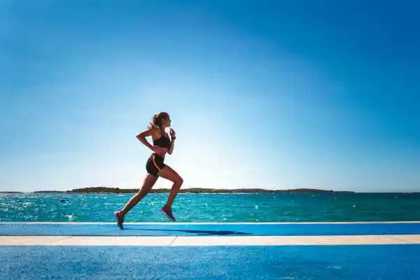 Woman running showing strong leg muscle Sunderland